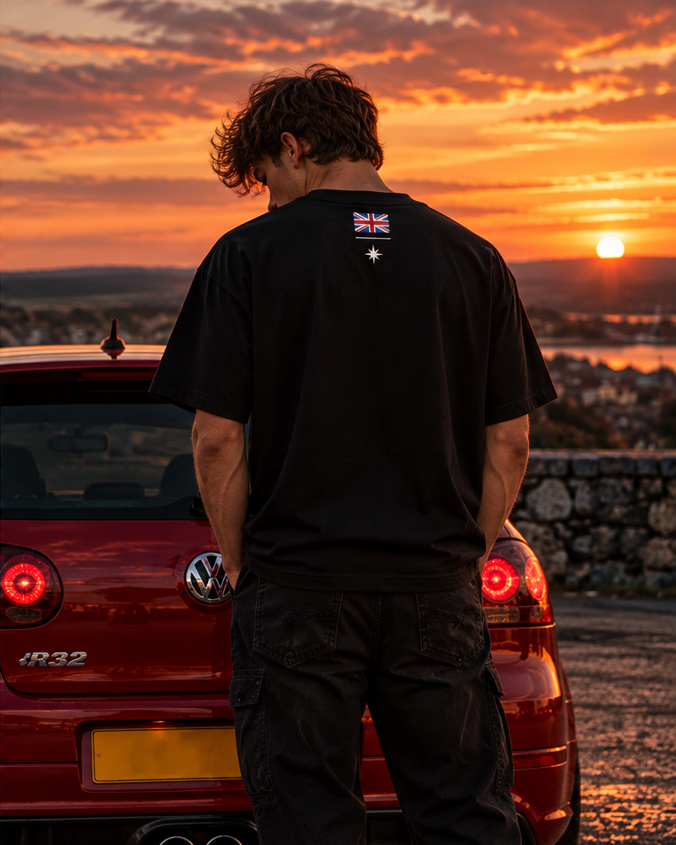 Back of the black British time tee on a model, with a small Union flag and a star below the collar