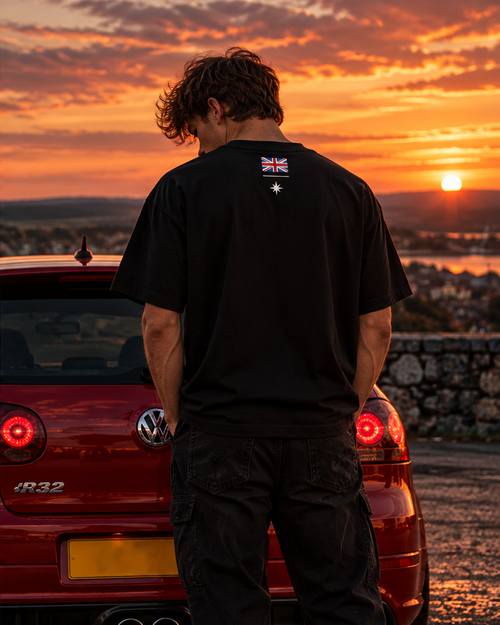 Back of the black British time tee on a model, with a small Union flag and a star below the collar